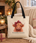 Highland Cow Bow tote by the fireplace